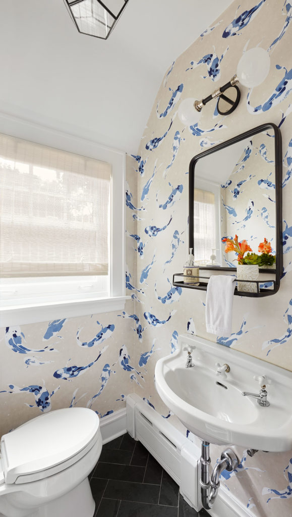 Small bathroom design with toilet, sink and colorful yet elegant wallpaper